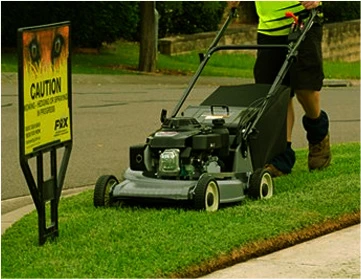 Fox Mowing operator working on a Canberra lawn